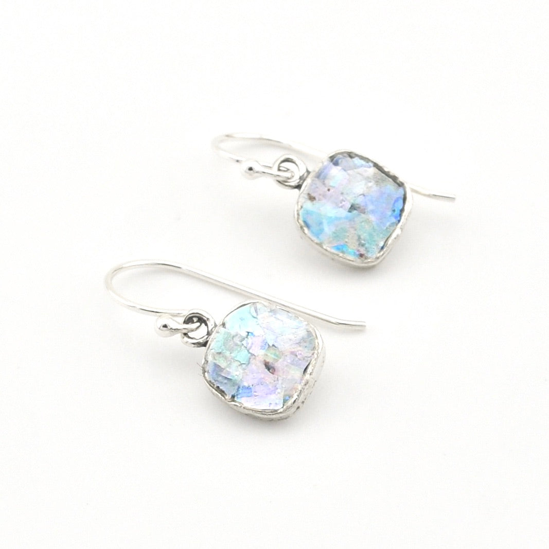 Silver earrings with Roman glass on a white background