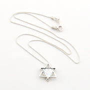 Silver necklace with a star-shaped pendant on a white background