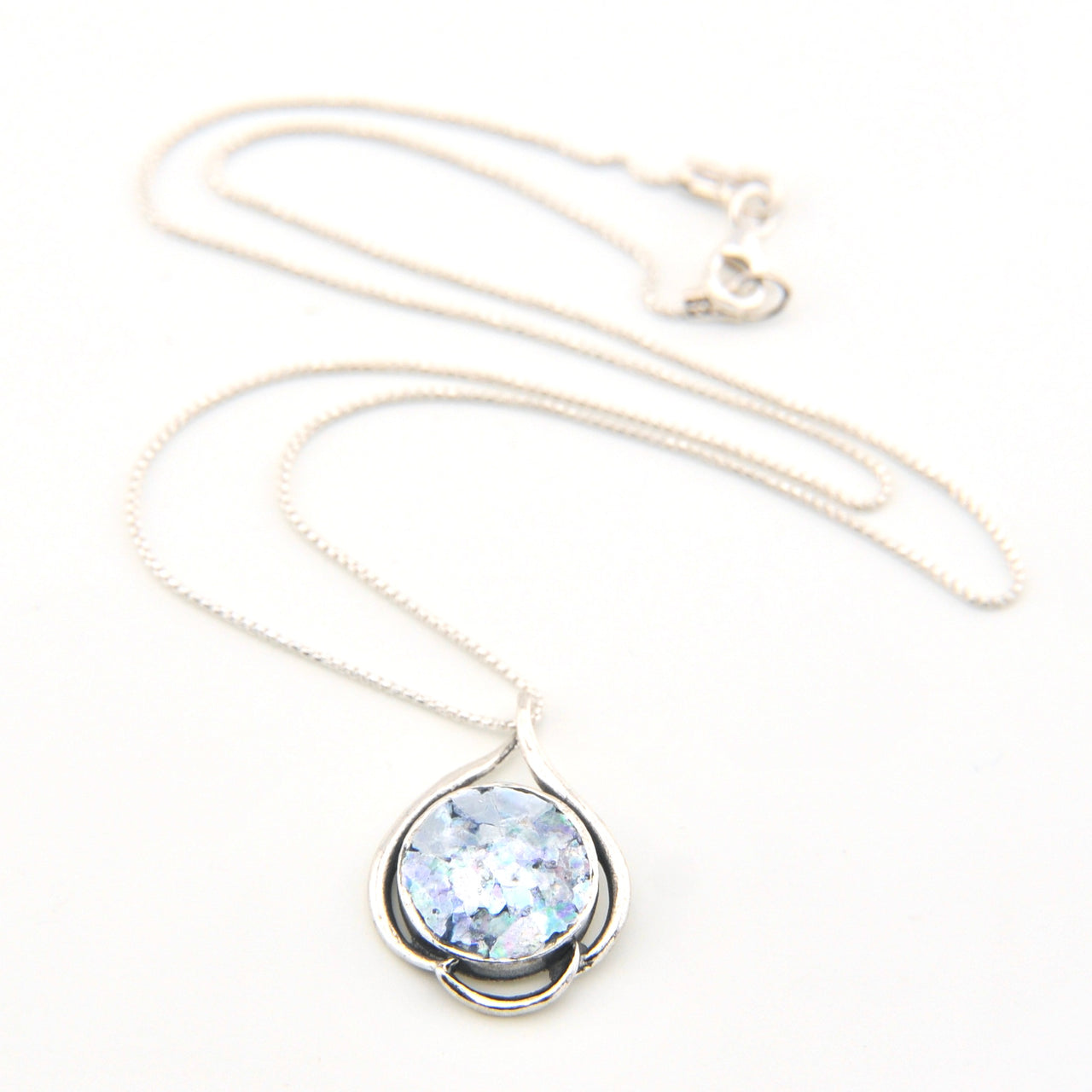 Necklace with a pendant featuring a blue gemstone on a white background