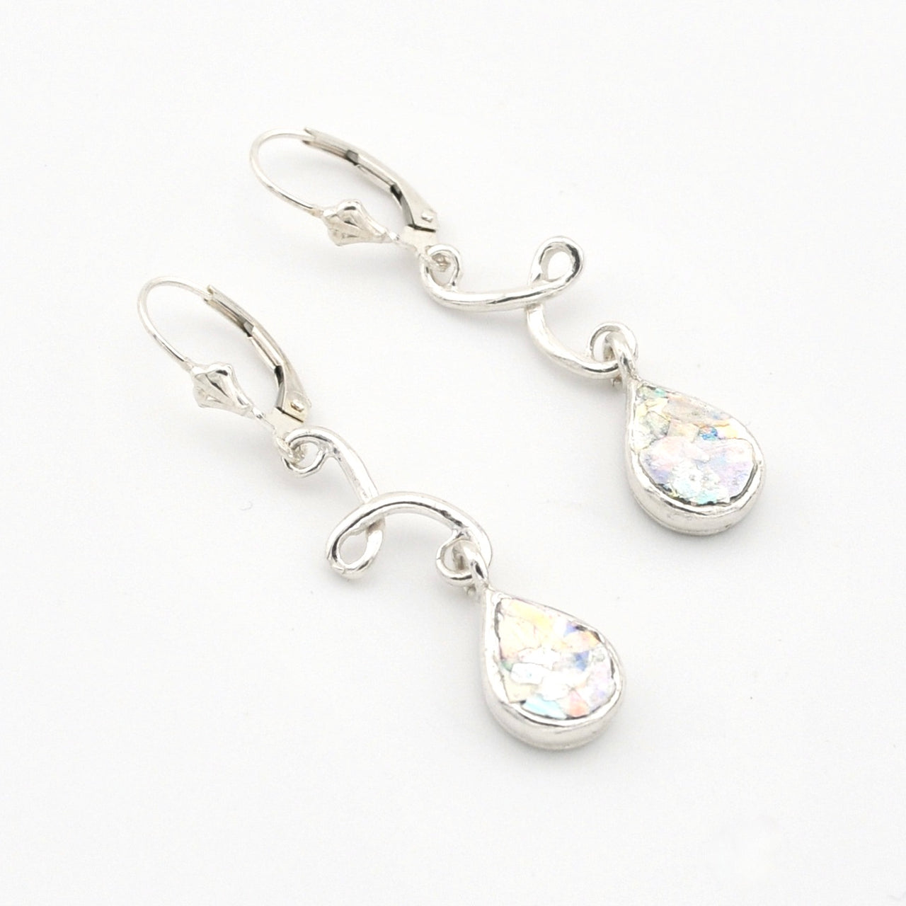 Silver teardrop earrings with Roman glass on a white background