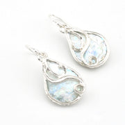 Silver teardrop earrings with a light blue Roman glass on a white background