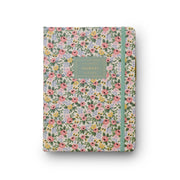Floral patterned journal with a green ribbon on a white background