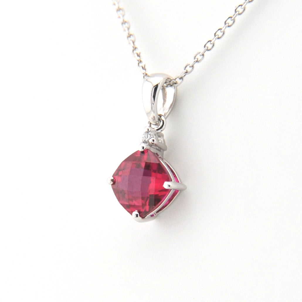 Necklace with a red square-shaped gemstone pendant on a white background