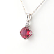 Necklace with a red square-shaped gemstone pendant on a white background