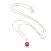 Silver necklace with a pink gemstone pendant on a white background