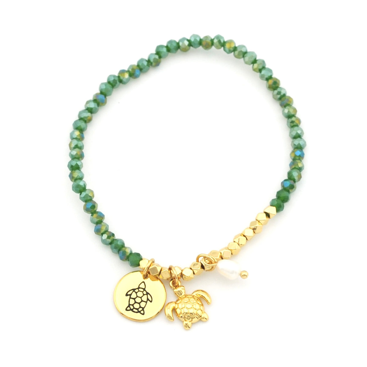 A beaded stretch bracelet featuring faceted green beads, gold-toned spacer beads, a round gold disc charm engraved with a sea turtle, and a small gold sea turtle charm, displayed on a clean white background.