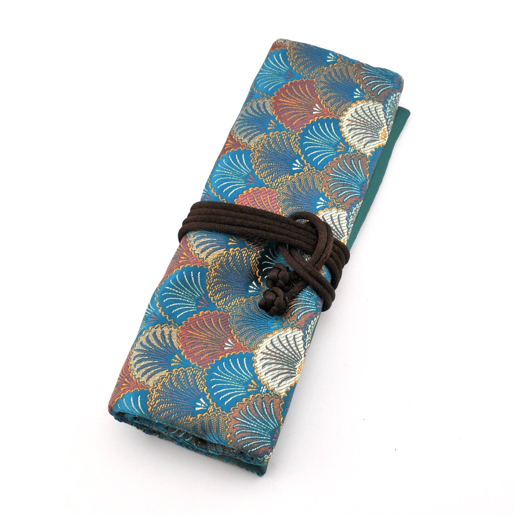 Folded fabric with shell pattern tied with a brown cord on a white background