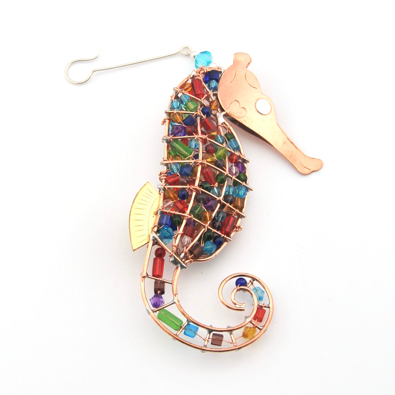 Colorful seahorse-shaped ornament with beads on a white background