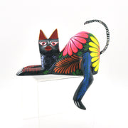 Colorful cat carving with floral patterns on a white background