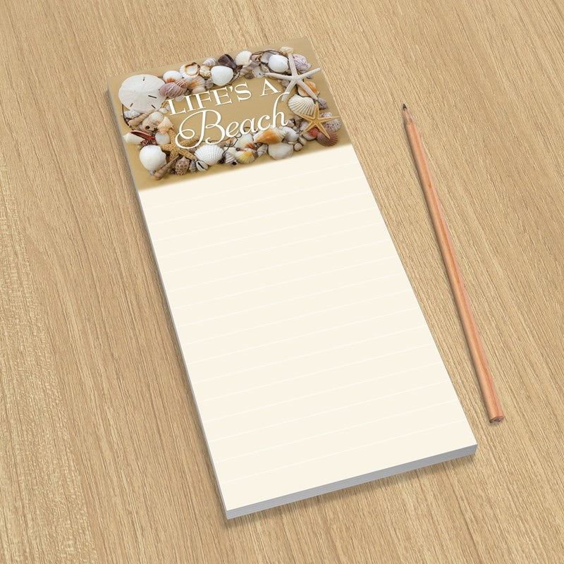 Notepad with beach-themed cover and pencil on a wooden surface