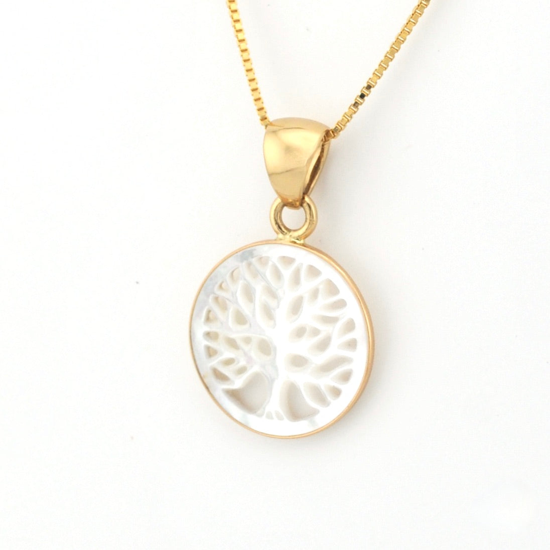 Gold necklace with a white tree-of-life pendant on a white background