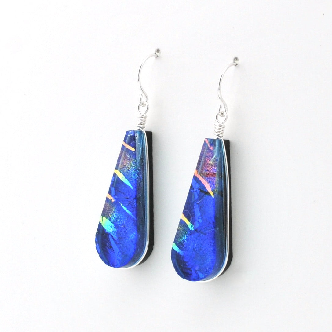 Dichroic Glass Rainbow Blue Tear Earrings on white background.