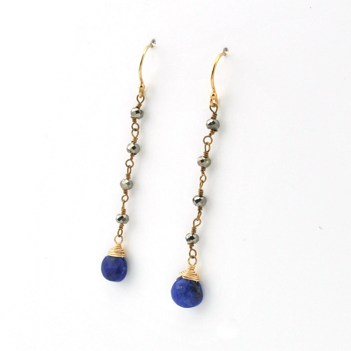A pair of gold drop earrings with small metallic beads and teardrop-shaped blue lapis lazuli stones, shown on a plain white background.