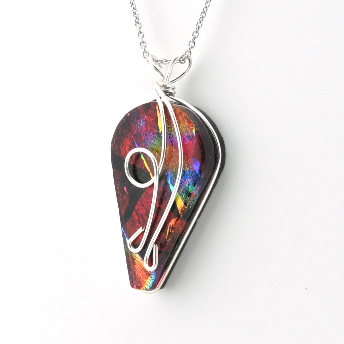 A silver wire-wrapped necklace featuring a teardrop-shaped pendant made from iridescent dichroic glass, shown on a plain white background.