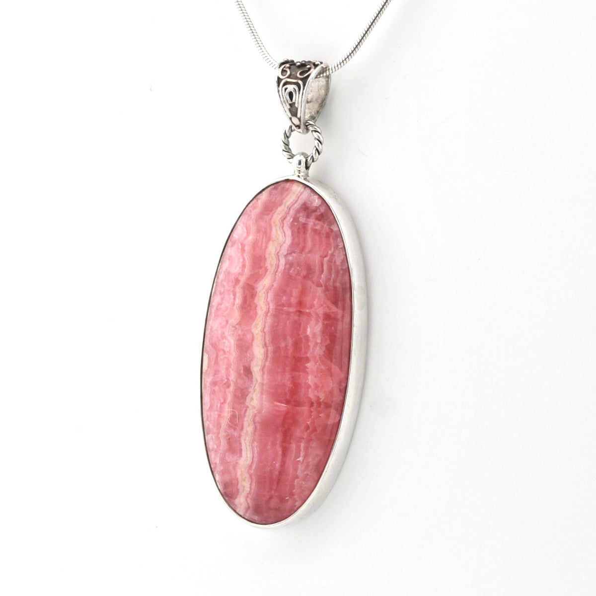 An oval pendant necklace featuring a pink and white striped mineral stone in a polished silver bezel setting, suspended from a silver chain against a plain white background.