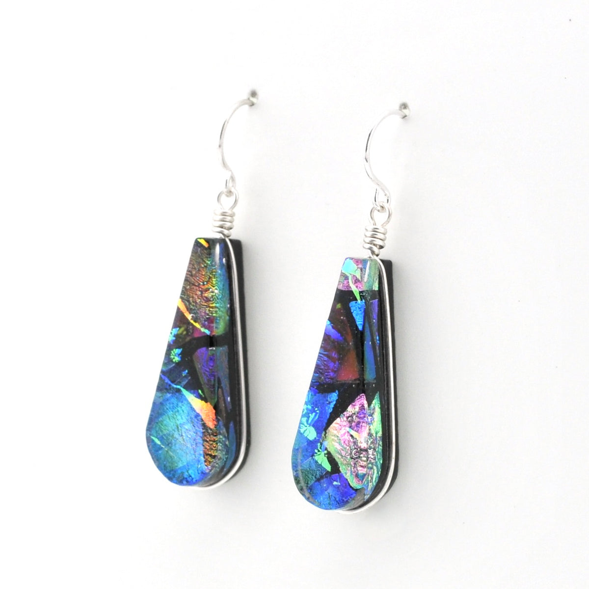A pair of teardrop-shaped dangle earrings featuring dichroic glass with silver wire-wrapping and silver fishhook wires, shown against a plain white background.