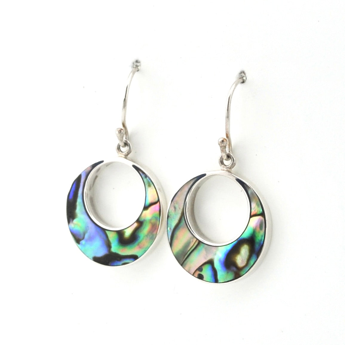 A pair of silver hoop earrings with iridescent abalone shell inlays, displayed against a clean white background.