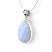 A silver teardrop pendant necklace featuring a light blue and lavender marbled stone, suspended from a delicate silver chain against a plain white background.