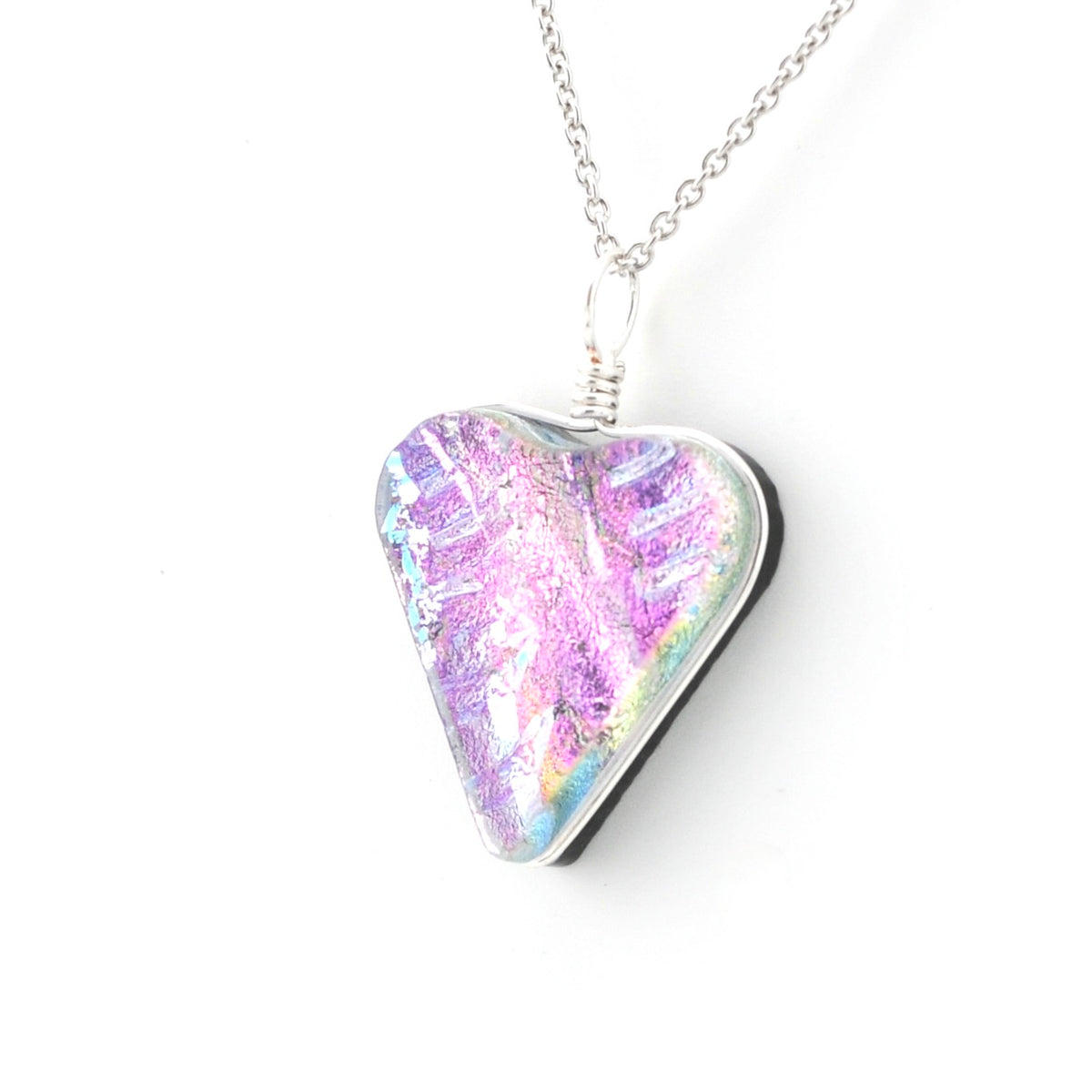 A silver heart-shaped pendant necklace featuring a holographic, iridescent surface with purple, pink, and blue shimmer, suspended from a silver chain against a plain white background.