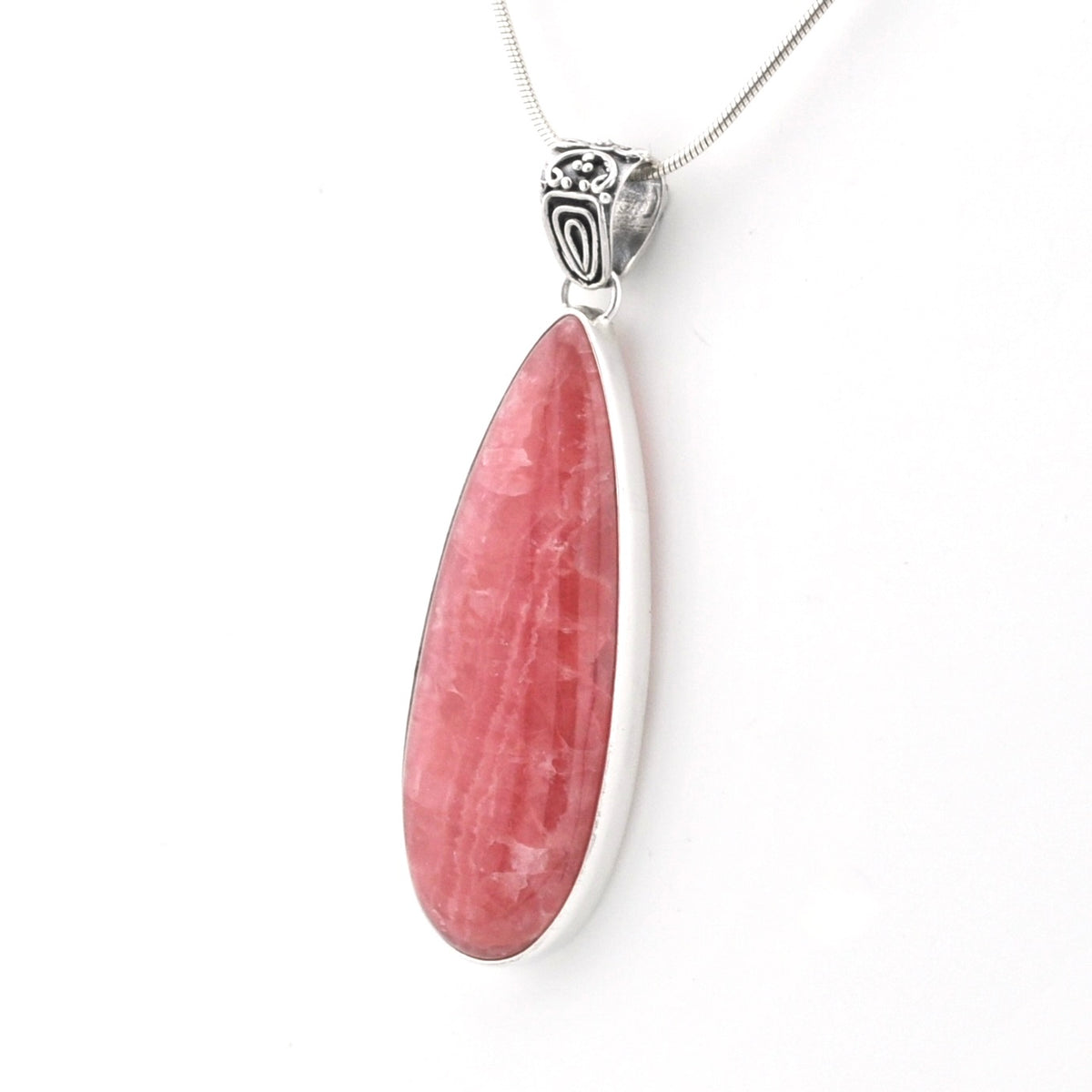 A teardrop-shaped pink gemstone pendant set in a polished silver bezel with a silver chain, shown on a plain white background.