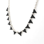 Shark teeth necklace on white backround.