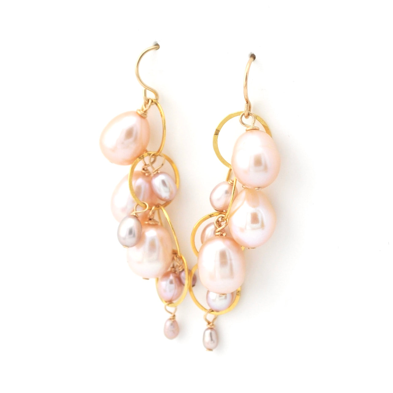 Pearl earrings with gold hooks on a white background