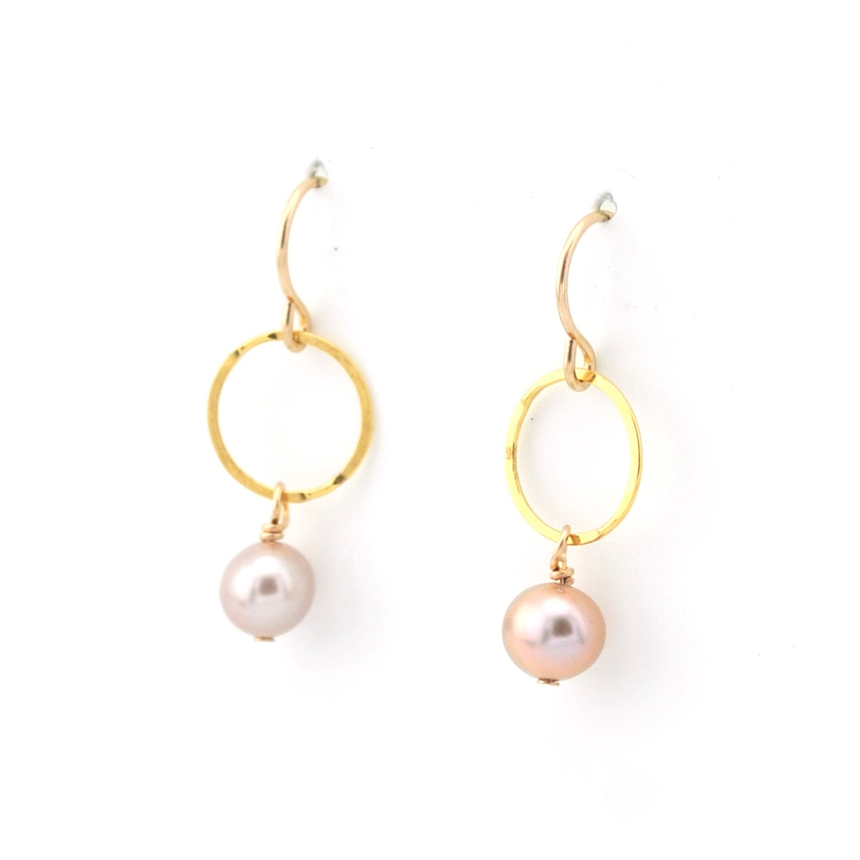 Gold hoop earrings with pearl drops on a white background