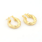 Pair of gold hoop earrings on a white background