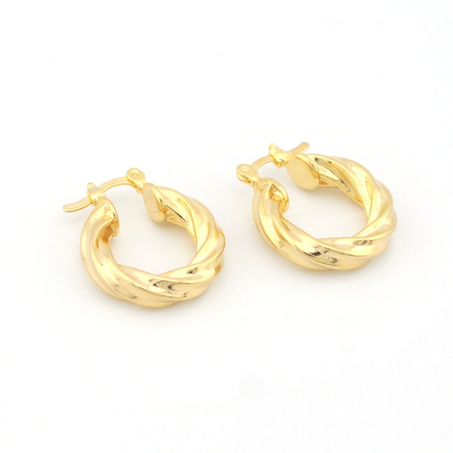 Pair of gold hoop earrings on a white background