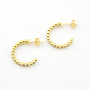 Gold hoop earrings on a white background