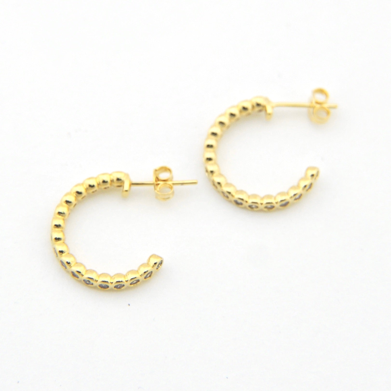 Gold hoop earrings on a white background