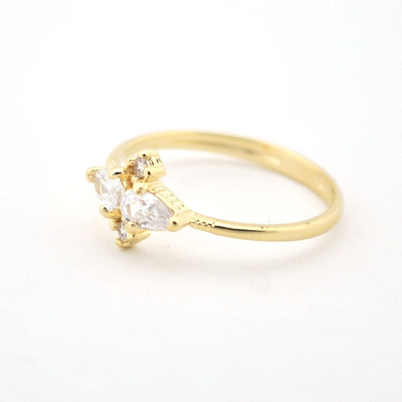 Gold ring with two pear-shaped cubic zirconias on a white background