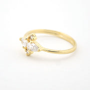 Gold ring with two pear-shaped cubic zirconias on a white background