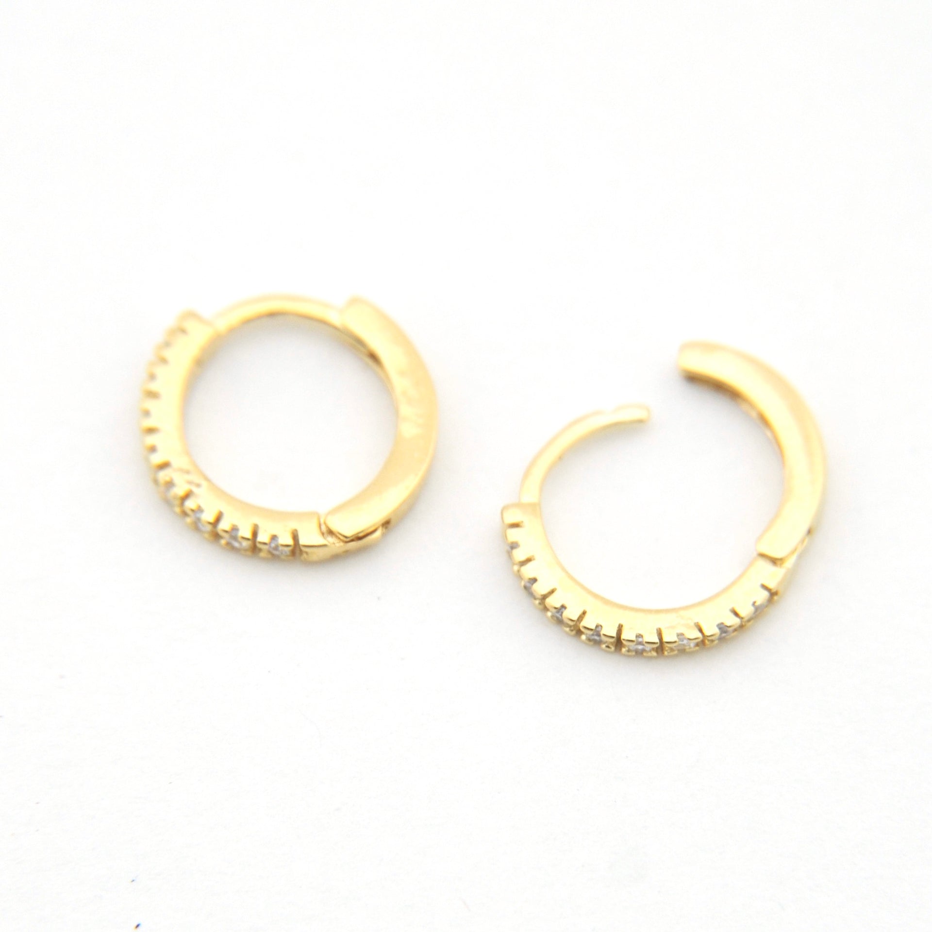 Gold hoop earrings on a white background