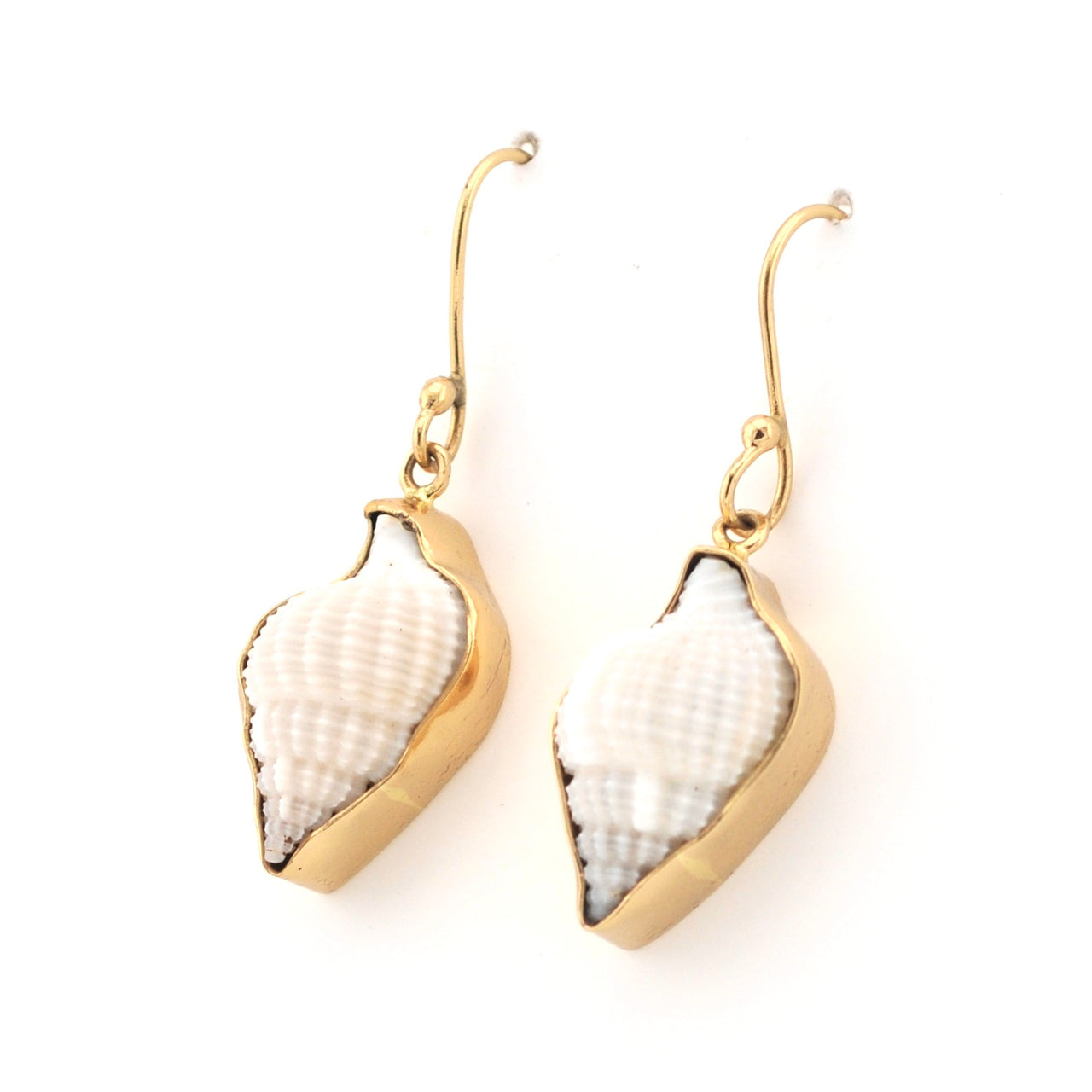 Pair of gold and white shell earrings on a white background