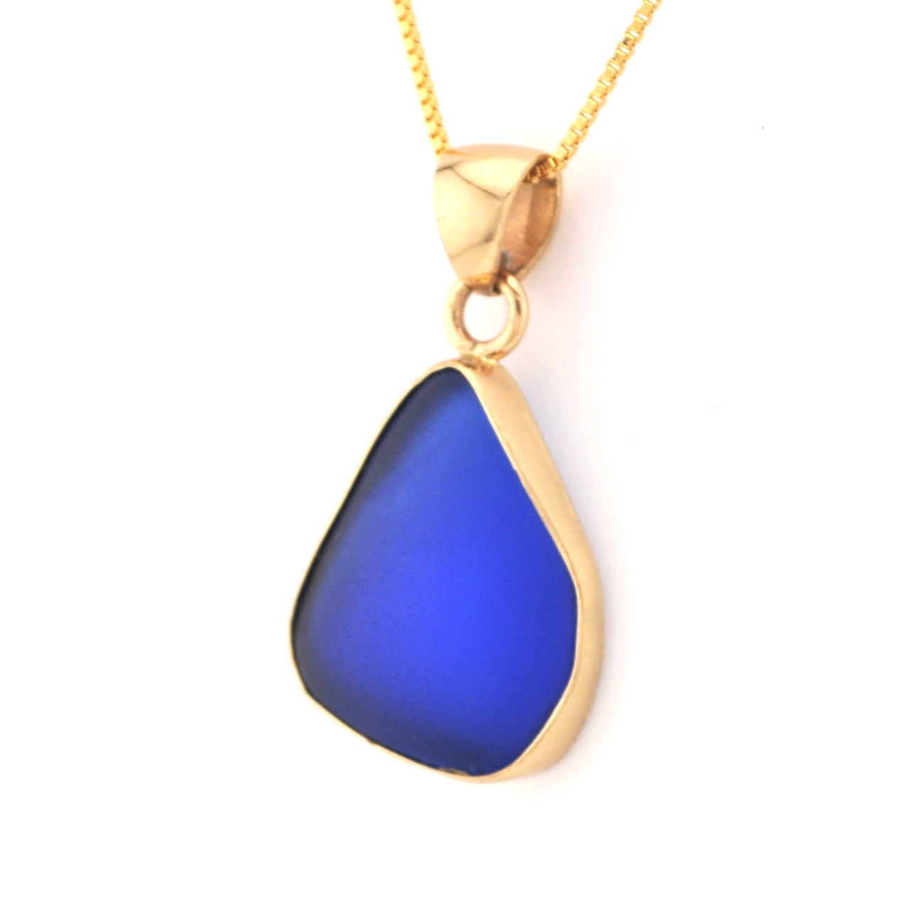 Blue teardrop pendant on a gold chain against a white background