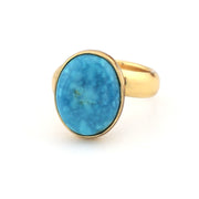 Turquoise and gold ring on white background
