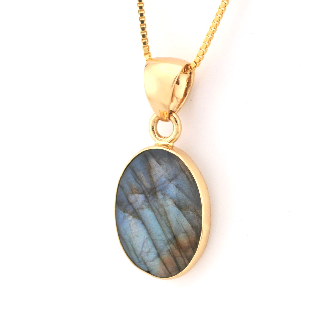 Gold pendant with a blue stone on a white background