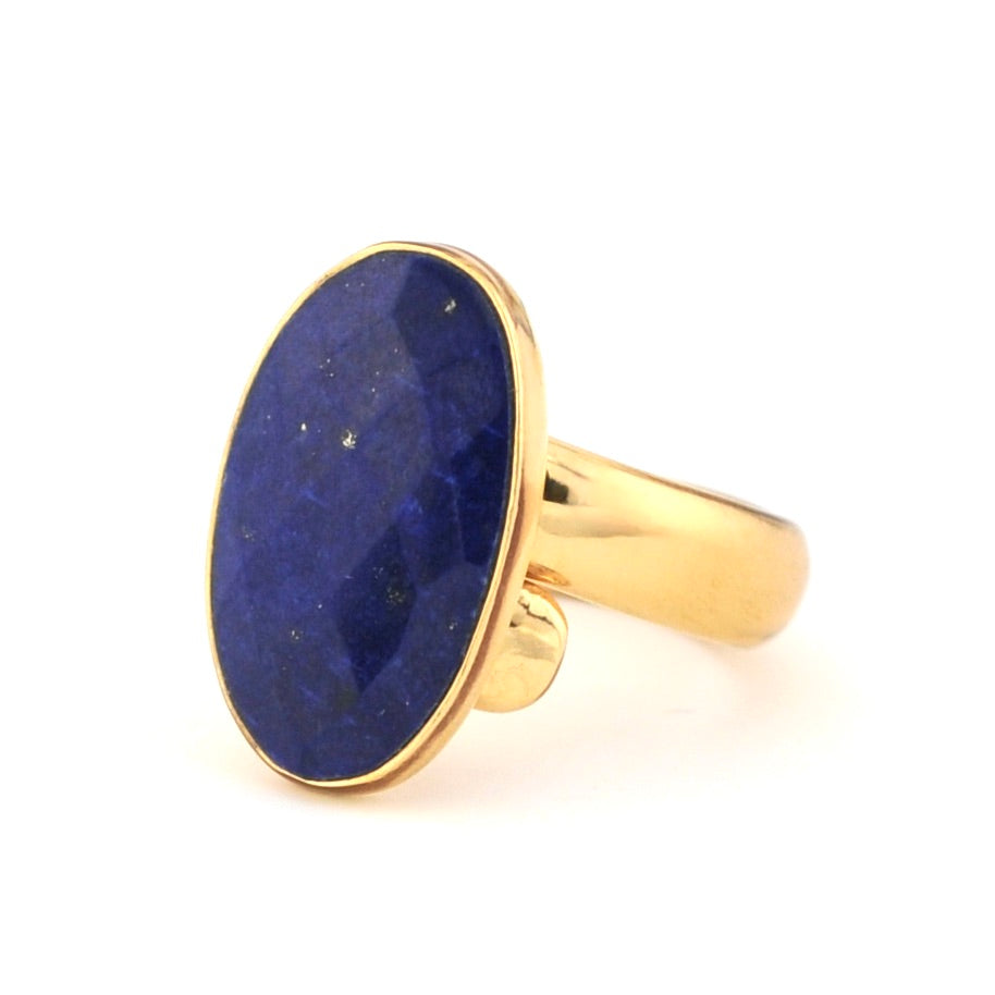 Gold ring with a blue stone on a white background
