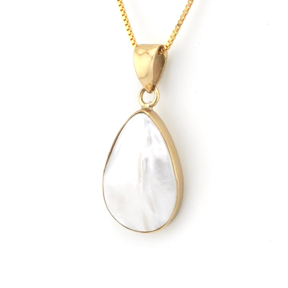 Gold necklace with a teardrop-shaped white pendant on a white background