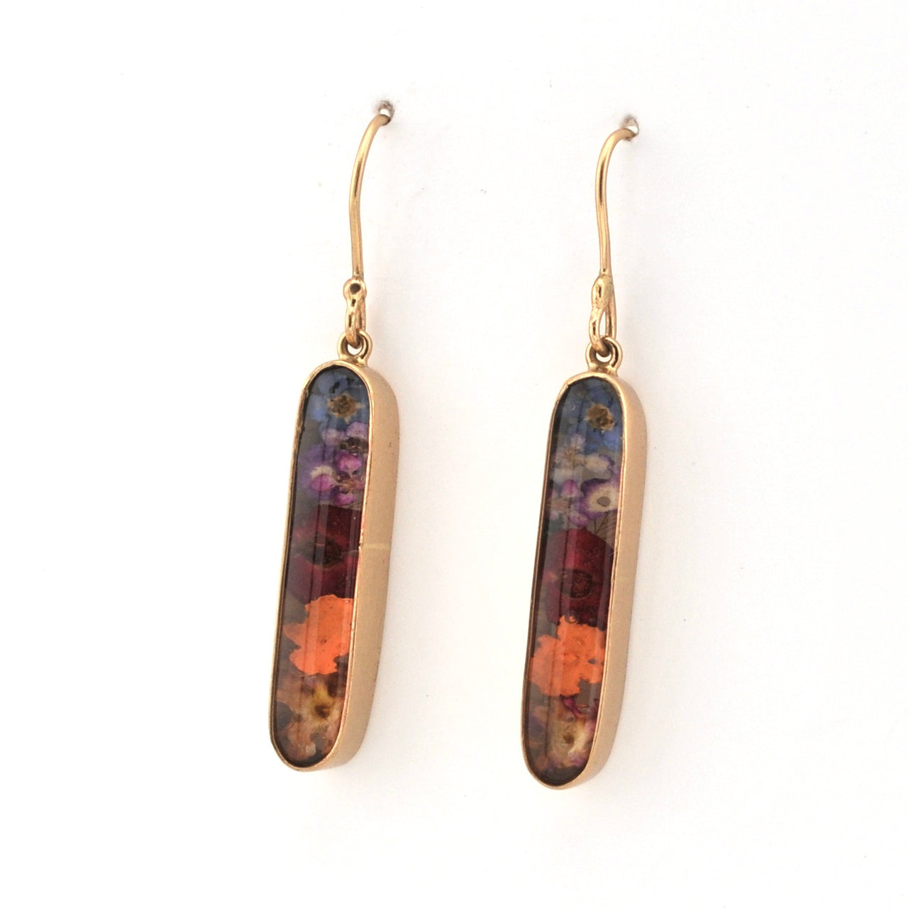 Pair of gold earrings with multicolored oval stones on a white background