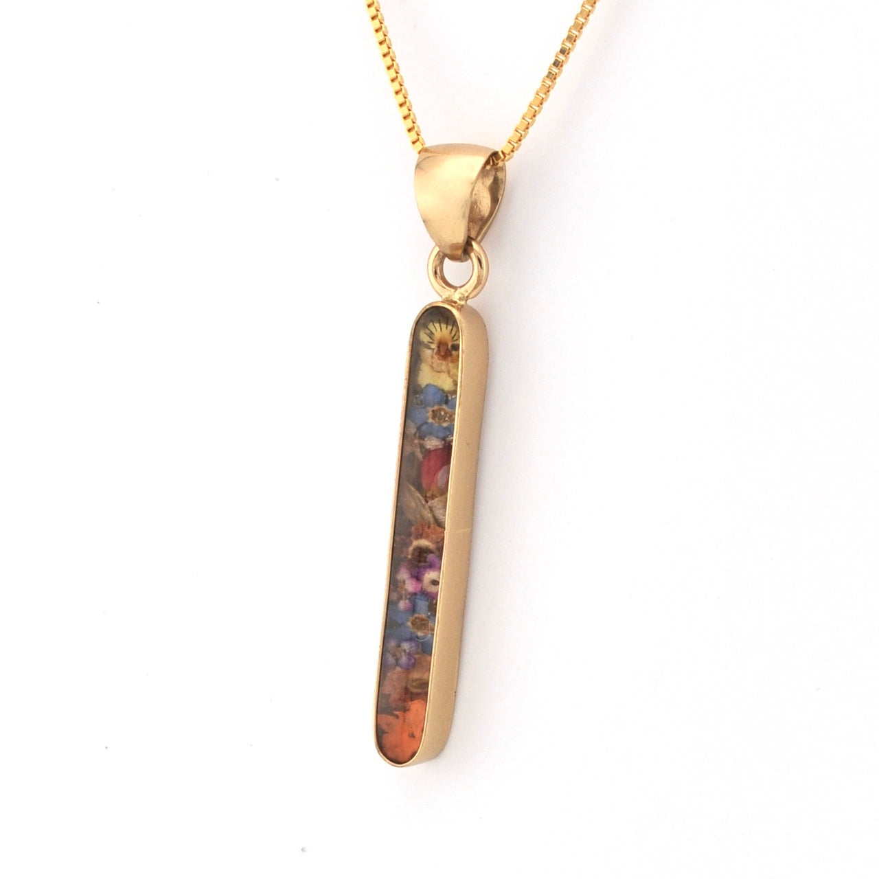 Gold pendant with a colorful design on a white background