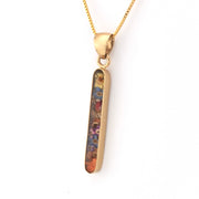 Gold pendant with a colorful design on a white background
