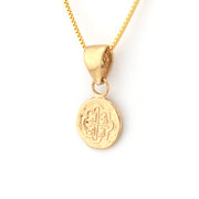 Gold necklace with a round pendant on a white background