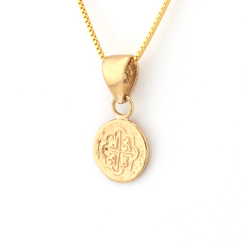 Gold necklace with a round pendant on a white background