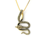 Gold snake pendant necklace on a white background