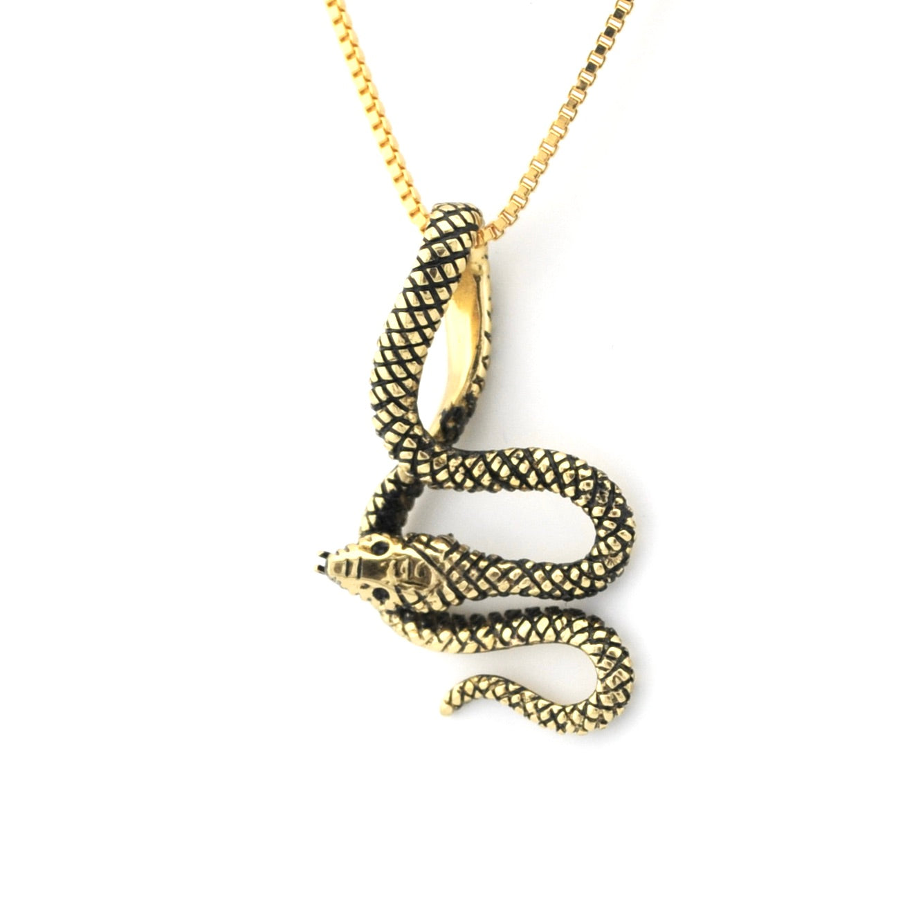 Gold snake pendant necklace on a white background