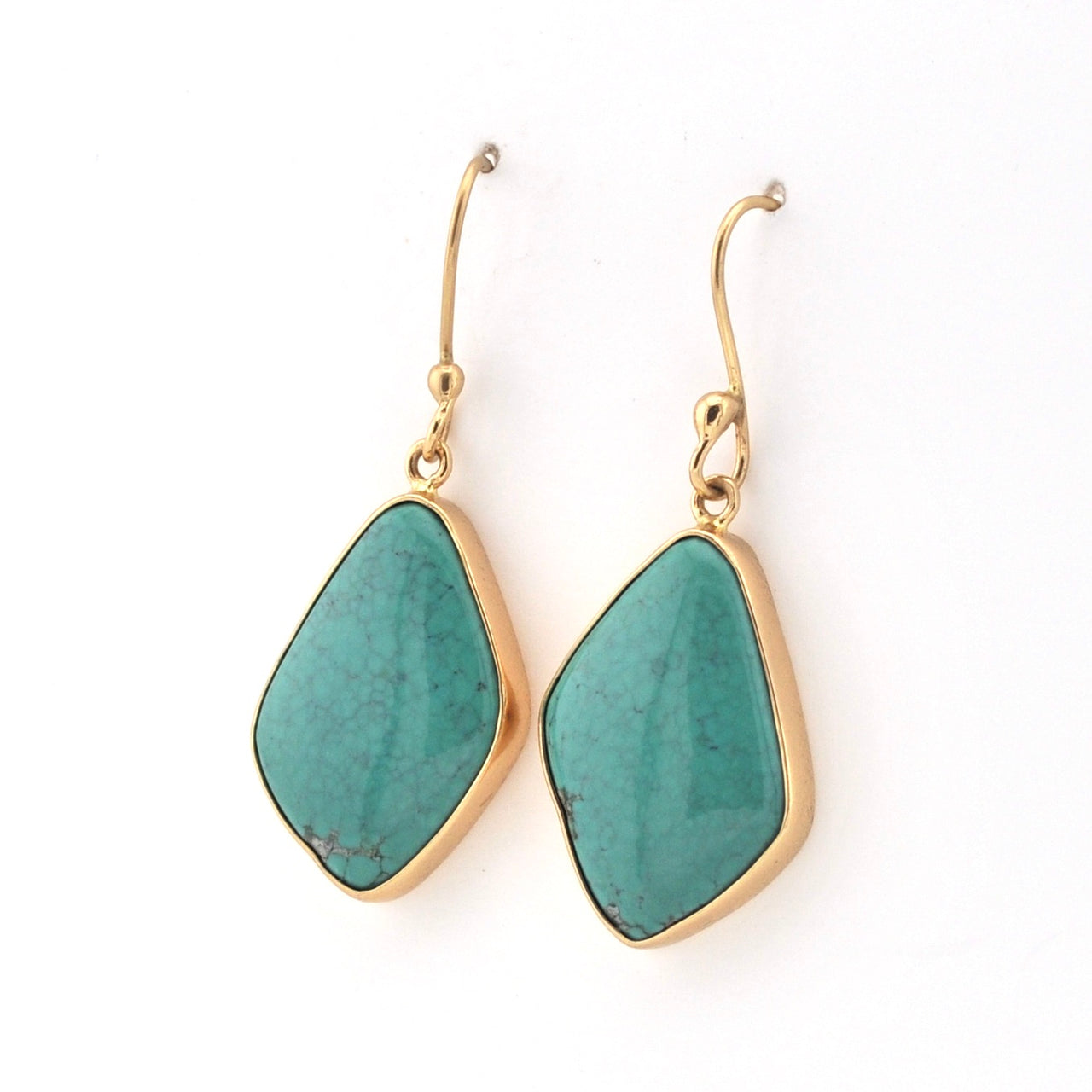 Turquoise earrings with gold hooks on a white background