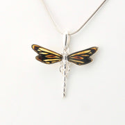 Dragonfly-shaped pendant on a white background