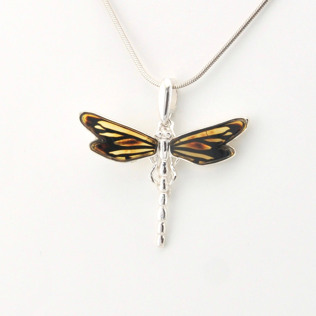 Dragonfly-shaped pendant on a white background
